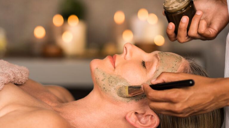Woman with clay mask on face